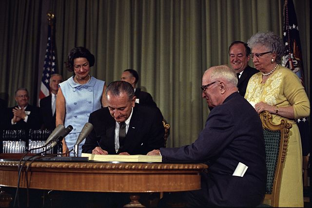 640px-Lyndon_Johnson_signing_Medicare_bill,_with_Harry_Truman,_July_30,_1965